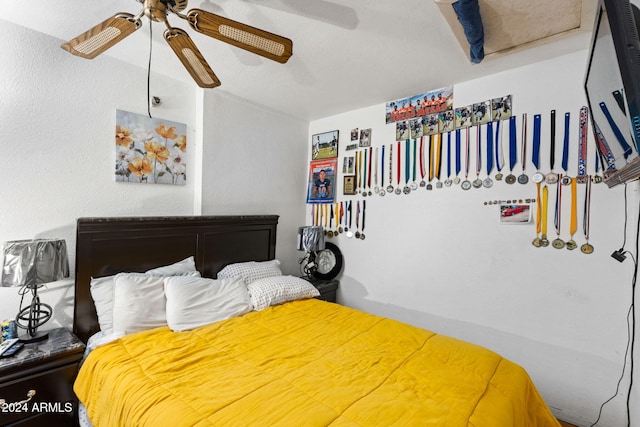 bedroom with a textured ceiling and ceiling fan