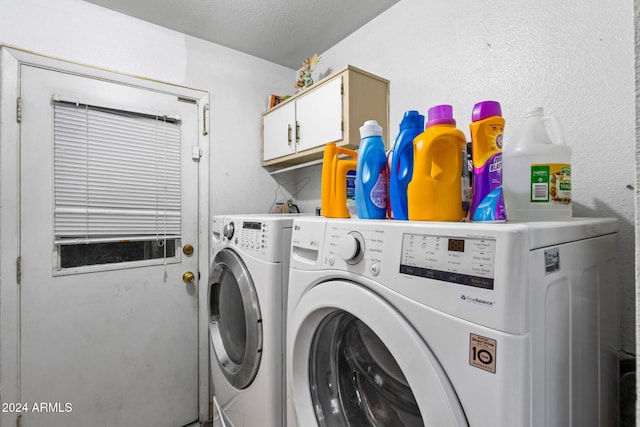 laundry room with cabinets, washer and dryer, and a textured ceiling