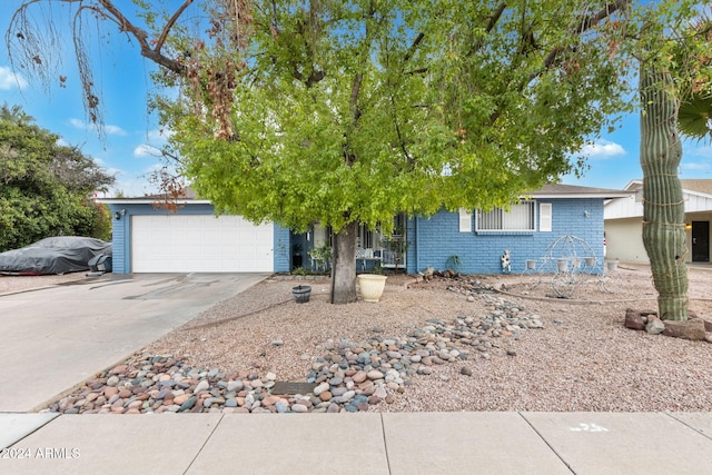 view of property hidden behind natural elements featuring a garage