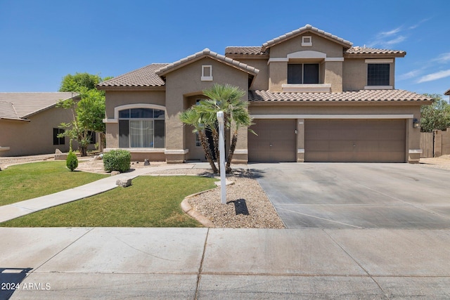 mediterranean / spanish-style house with a garage and a front lawn