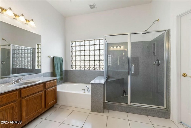 bathroom featuring tile patterned floors, plus walk in shower, and vanity