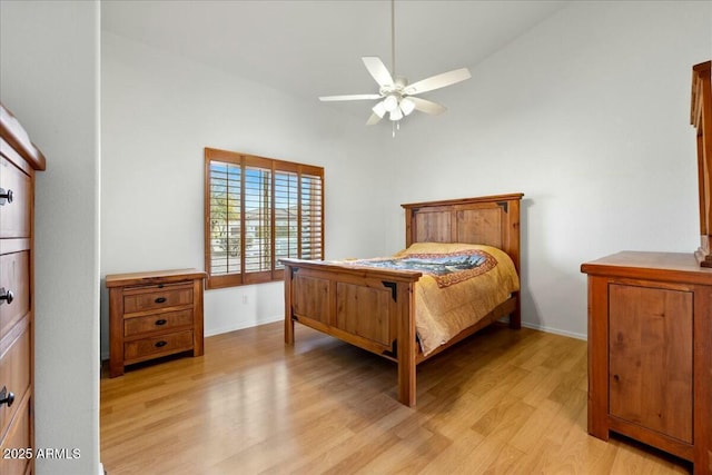 bedroom featuring ceiling fan, lofted ceiling, and light hardwood / wood-style floors