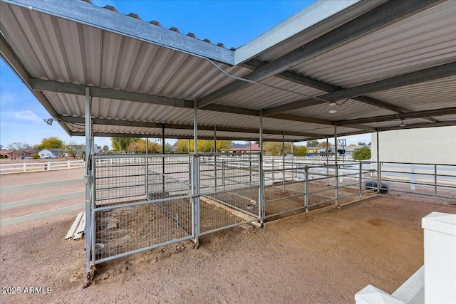 view of horse barn with a rural view