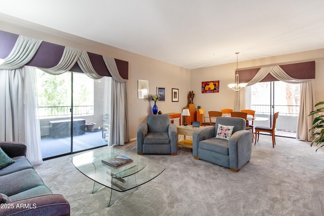 carpeted living area with a chandelier