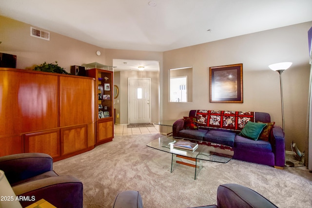 carpeted living area with visible vents and tile patterned floors