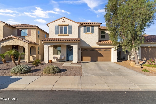 mediterranean / spanish house with a garage