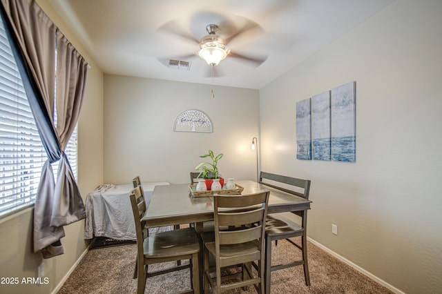 dining room with carpet flooring, a ceiling fan, healthy amount of natural light, and baseboards