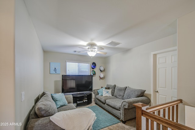 carpeted living area with ceiling fan