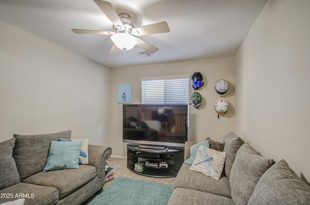 carpeted living area with a ceiling fan