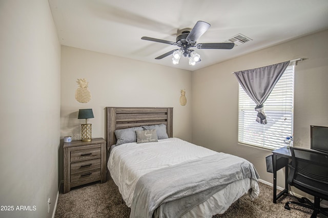 carpeted bedroom featuring baseboards and a ceiling fan