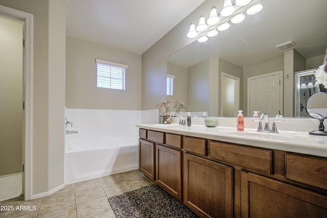 full bathroom featuring a garden tub, tile patterned flooring, and double vanity