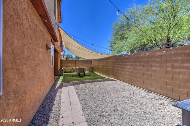 fenced backyard featuring a patio area
