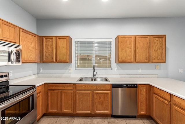 kitchen featuring appliances with stainless steel finishes, sink, and light tile patterned floors