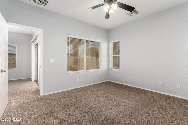 empty room with ceiling fan and carpet