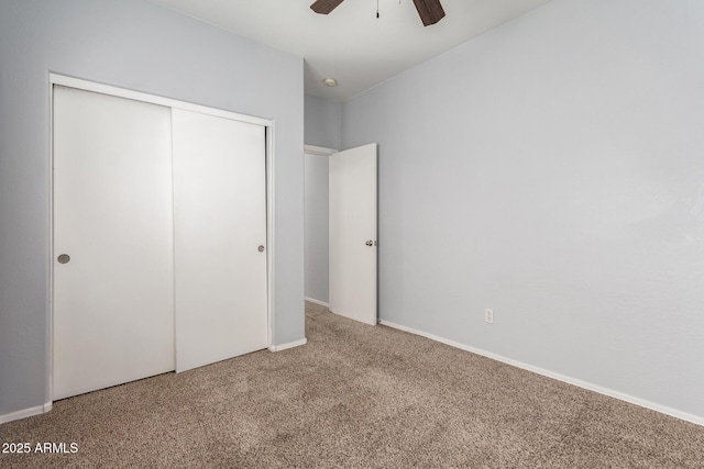 unfurnished bedroom with carpet, ceiling fan, and a closet