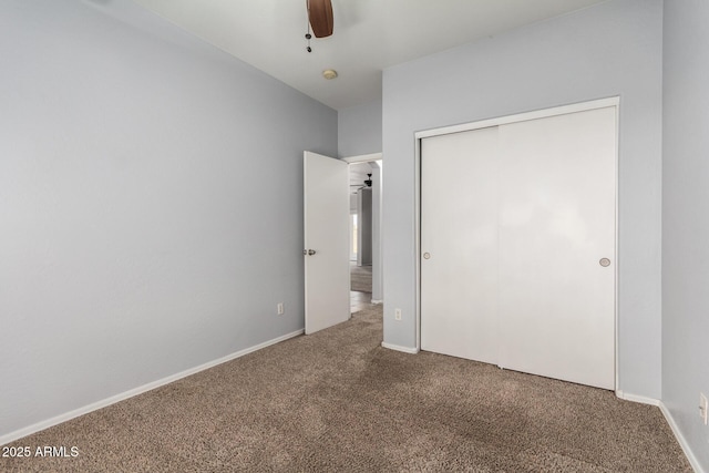 unfurnished bedroom featuring ceiling fan, a closet, and carpet