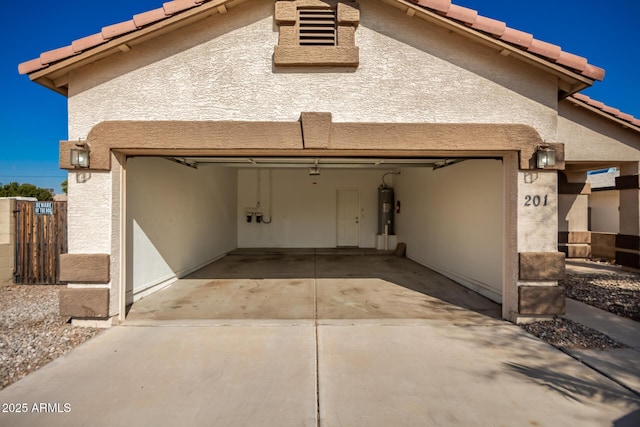 exterior space with a garage and water heater