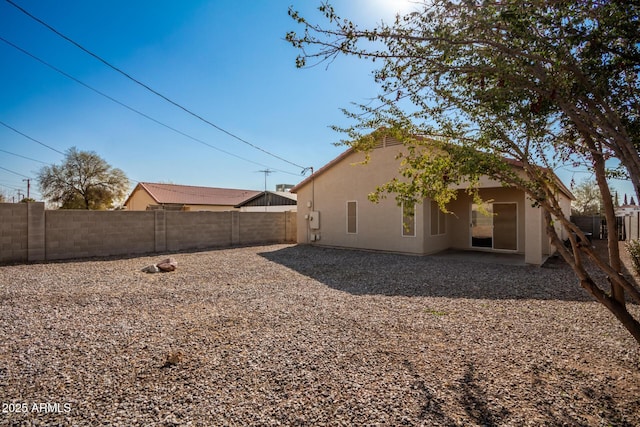 back of property with a patio