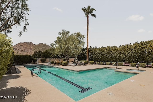 view of pool with a mountain view, sink, and a patio