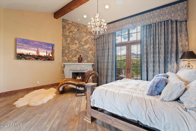 bedroom featuring vaulted ceiling with beams, french doors, hardwood / wood-style floors, and a chandelier