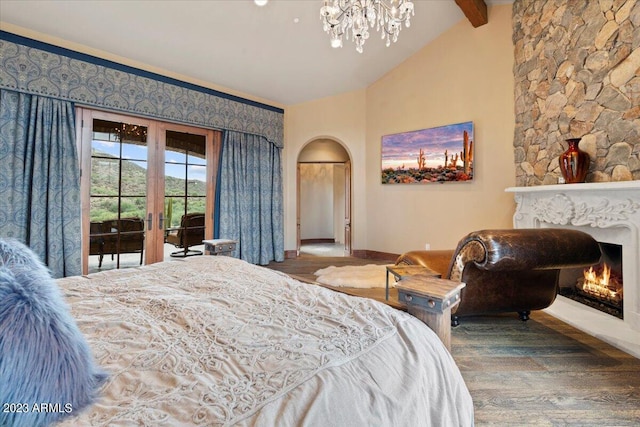 bedroom featuring vaulted ceiling with beams, wood-type flooring, and access to outside