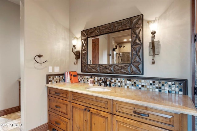 bathroom with vanity and tasteful backsplash