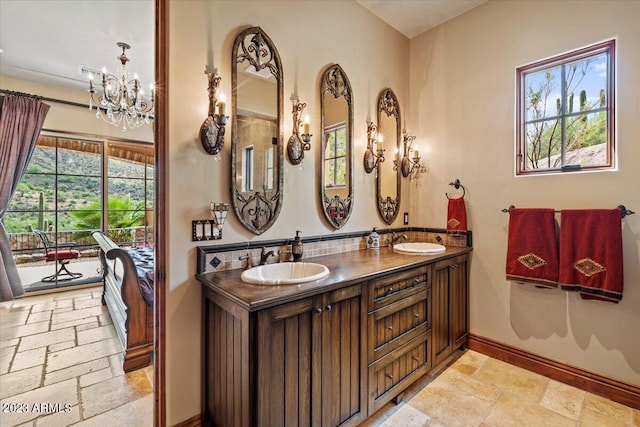 bathroom with vanity and an inviting chandelier