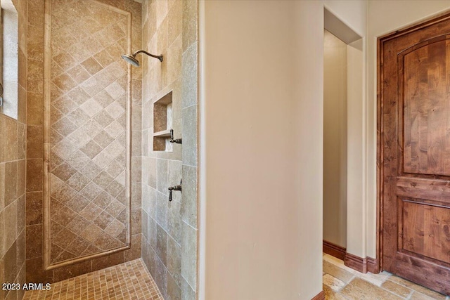 bathroom with tiled shower