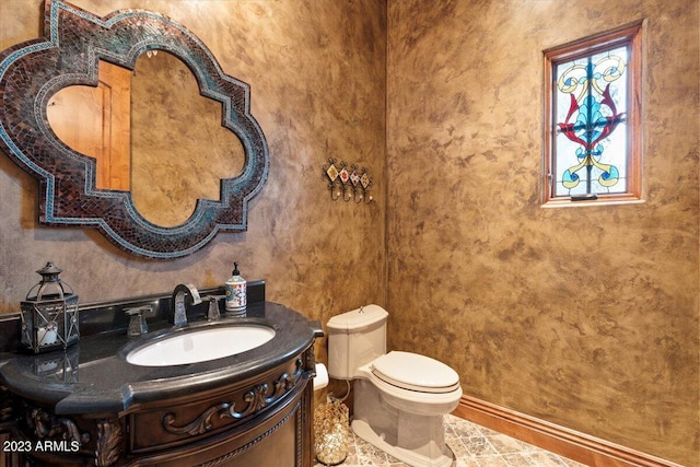 bathroom with toilet and vanity