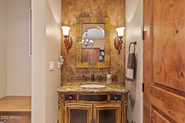 bathroom featuring vanity and a notable chandelier