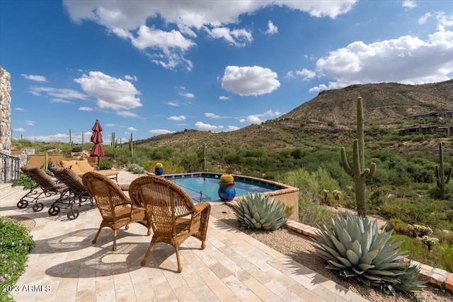 view of pool featuring a patio and a mountain view