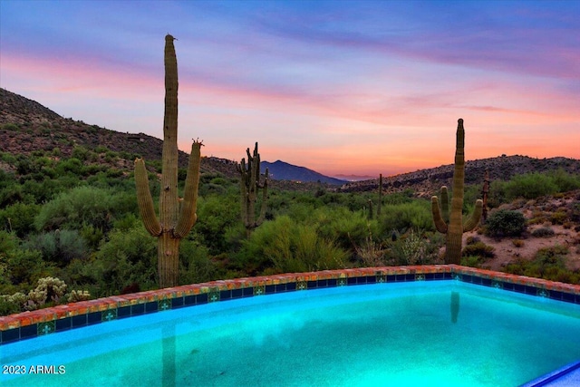 pool at dusk with a mountain view