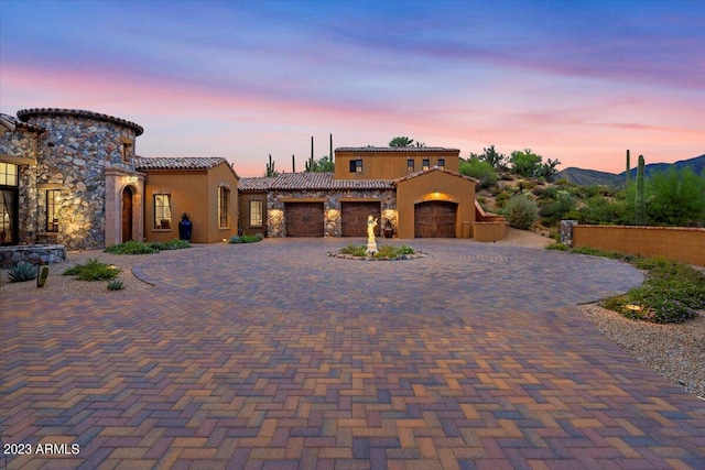 mediterranean / spanish-style home featuring a garage and a mountain view