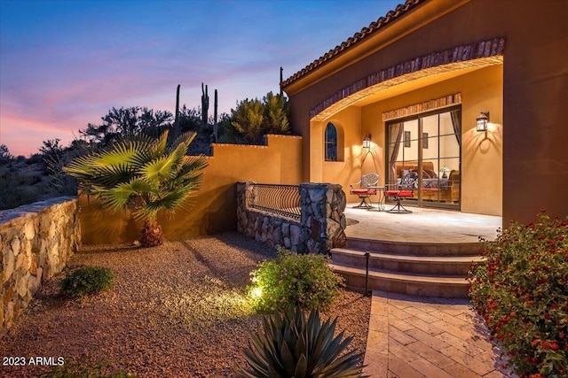 view of patio terrace at dusk