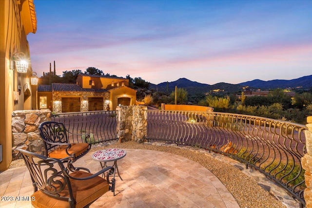 patio terrace at dusk with a mountain view