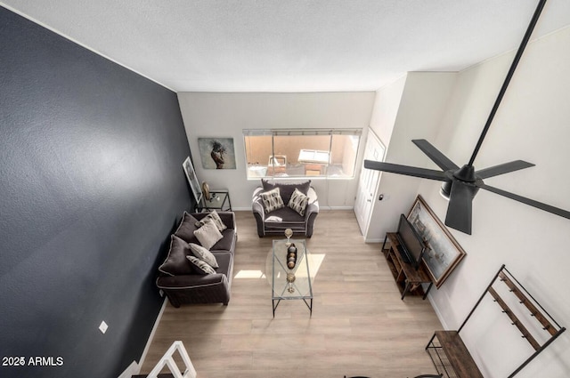 living room with ceiling fan and light wood-type flooring