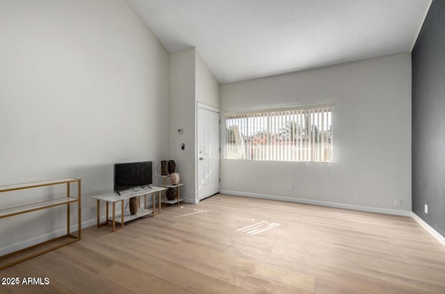 interior space featuring vaulted ceiling and light hardwood / wood-style flooring