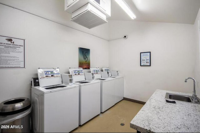 clothes washing area featuring sink and washing machine and clothes dryer