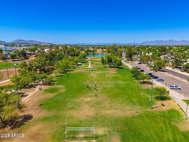 drone / aerial view featuring a water and mountain view