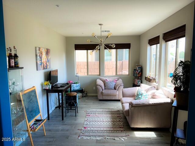 3871 E Harrison St, Gilbert, AZ 85295 - interior space with baseboards, visible vents, wood finished floors, and an inviting chandelier