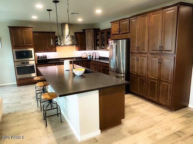 3871 E Harrison St, Gilbert, AZ 85295 - kitchen with recessed lighting, dark countertops, appliances with stainless steel finishes, and wall chimney range hood