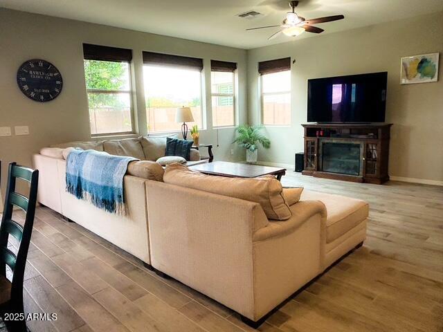 3871 E Harrison St, Gilbert, AZ 85295 - living area featuring a ceiling fan, visible vents, wood finished floors, and a healthy amount of sunlight