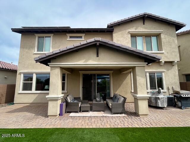 3871 E Harrison St, Gilbert, AZ 85295 - back of property featuring a patio, an outdoor living space, and stucco siding