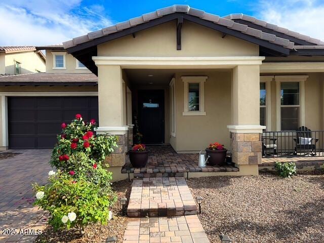 3871 E Harrison St, Gilbert, AZ 85295 - view of exterior entry with driveway, stucco siding, covered porch, and a tiled roof