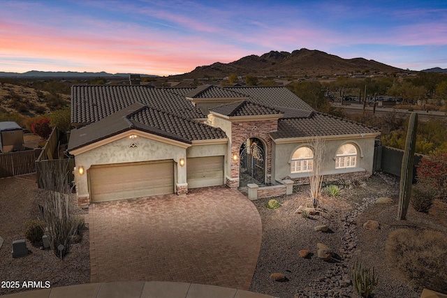 mediterranean / spanish home featuring a mountain view and a garage