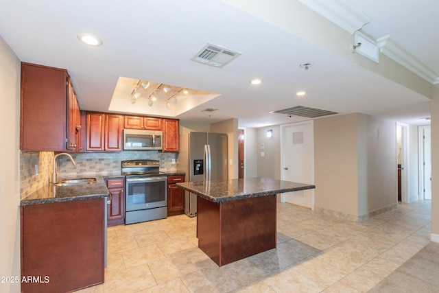 7970 E Camelback Rd Unit 604, Scottsdale, AZ 85251 - kitchen with stainless steel appliances, a sink, tasteful backsplash, a center island, and dark stone countertops