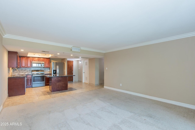 7970 E Camelback Rd Unit 604, Scottsdale, AZ 85251 - kitchen featuring appliances with stainless steel finishes, a center island, light colored carpet, ornamental molding, and open floor plan