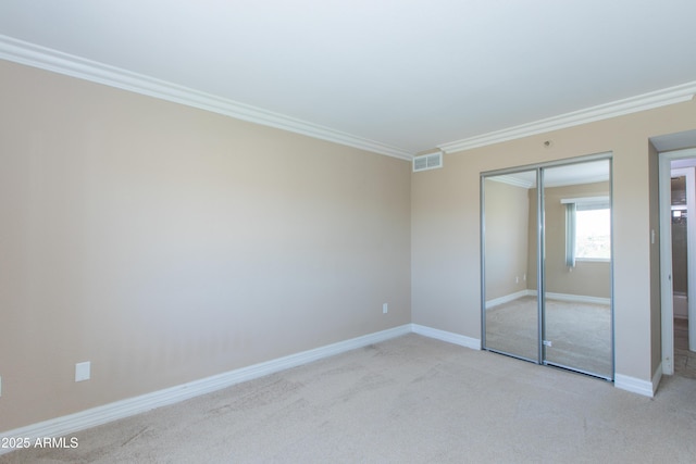 7970 E Camelback Rd Unit 604, Scottsdale, AZ 85251 - unfurnished bedroom featuring ornamental molding, light carpet, a closet, and baseboards