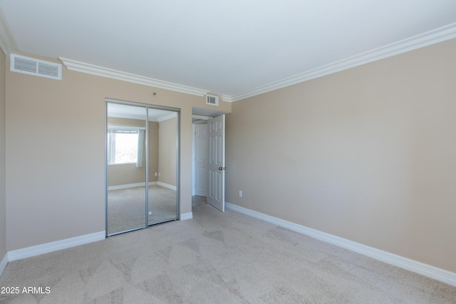 7970 E Camelback Rd Unit 604, Scottsdale, AZ 85251 - unfurnished bedroom featuring ornamental molding, carpet, a closet, and baseboards