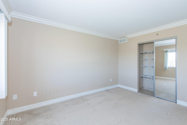 7970 E Camelback Rd Unit 604, Scottsdale, AZ 85251 - unfurnished bedroom with crown molding, light colored carpet, a closet, and baseboards
